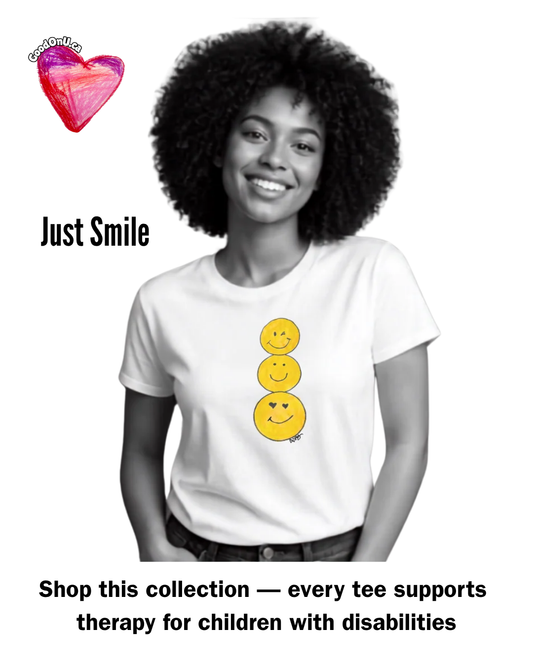 Model smiling and wearing a white Just Smile tee by Ashley Caldwell. Text reads: Shop this collection — every tee supports therapy for children with disabilities.