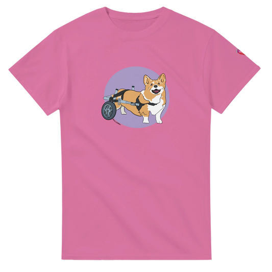 Pink t-shirt with a corgi in a wheelchair graphic on a white background