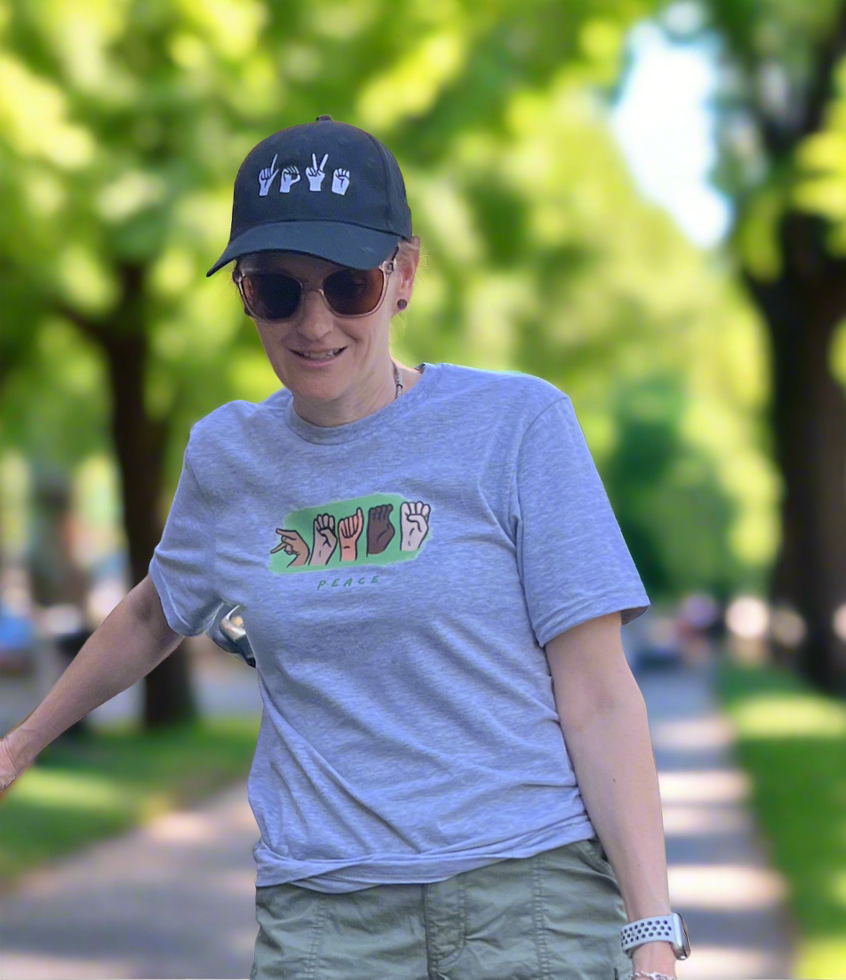 Picture of women waring SIGN PEACE shirt with American Sign Language hand gesture for peace and communication accessibility. 
