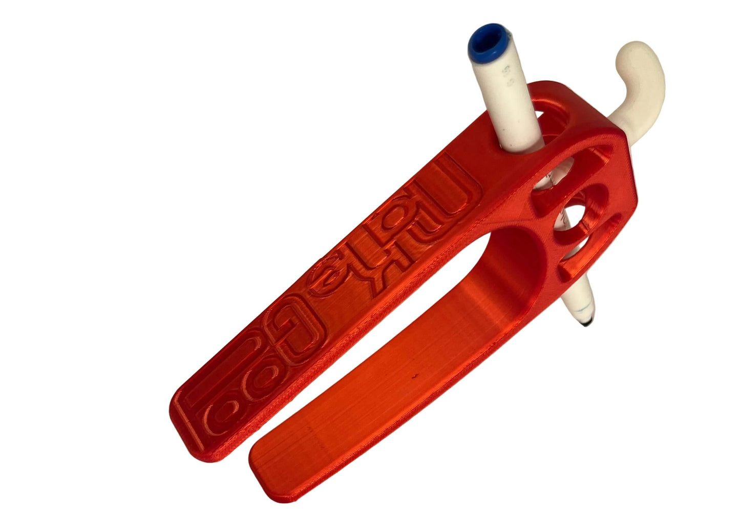 MakeGood Red assistive device for holding pens and pencils. 