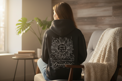 Black hoodie with a sunflower design and text on the back against a white background