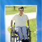 Book cover background is clouds with the title Above and Beyond picture is Anthony Frisina in his wheelchair on a paved park pathway. Another name is on the bottom Anthony Frisina 